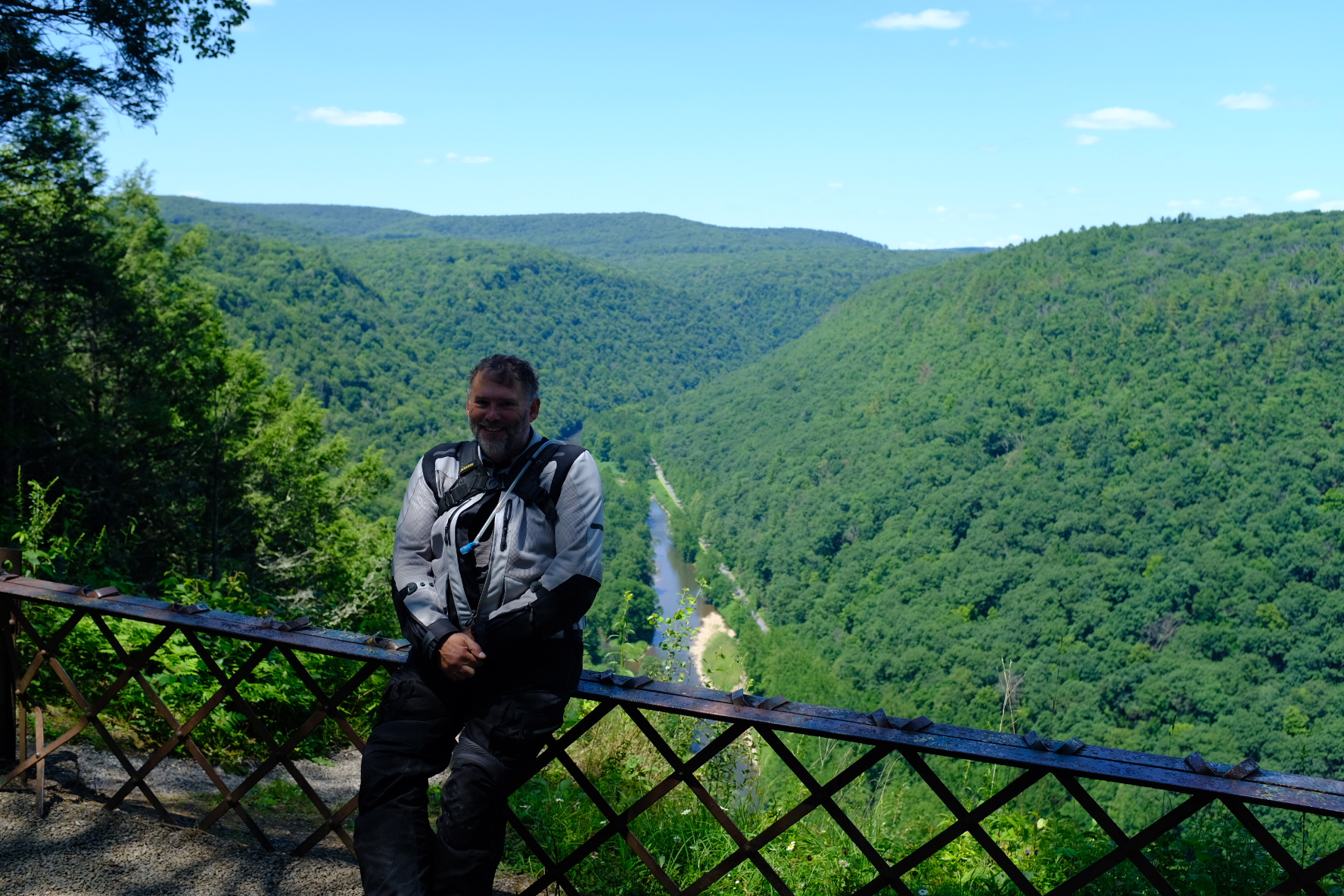 Rider leaning on a railing above the Pine Creek gorge at the PA Grand Canyon