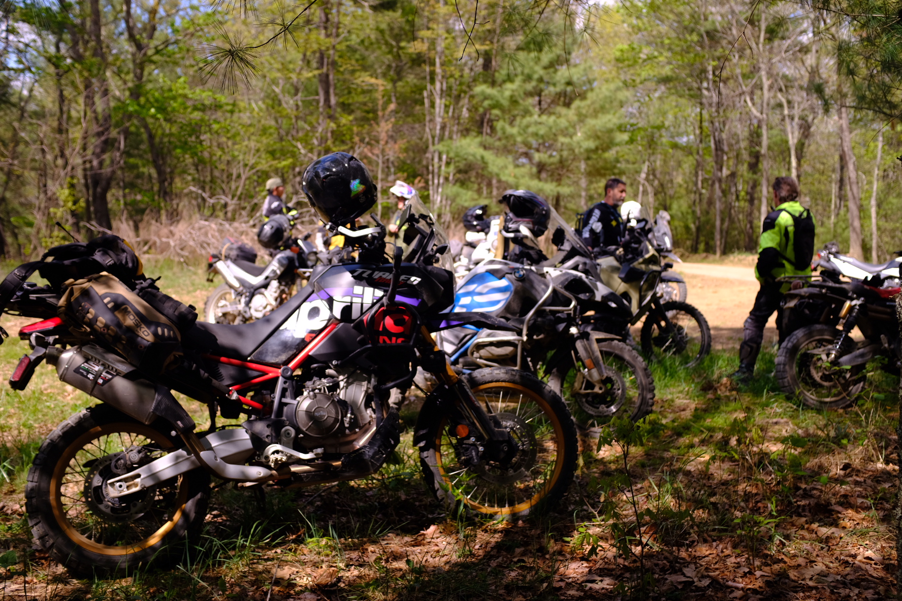 Group of ADV bikes parked at a stop in the forest