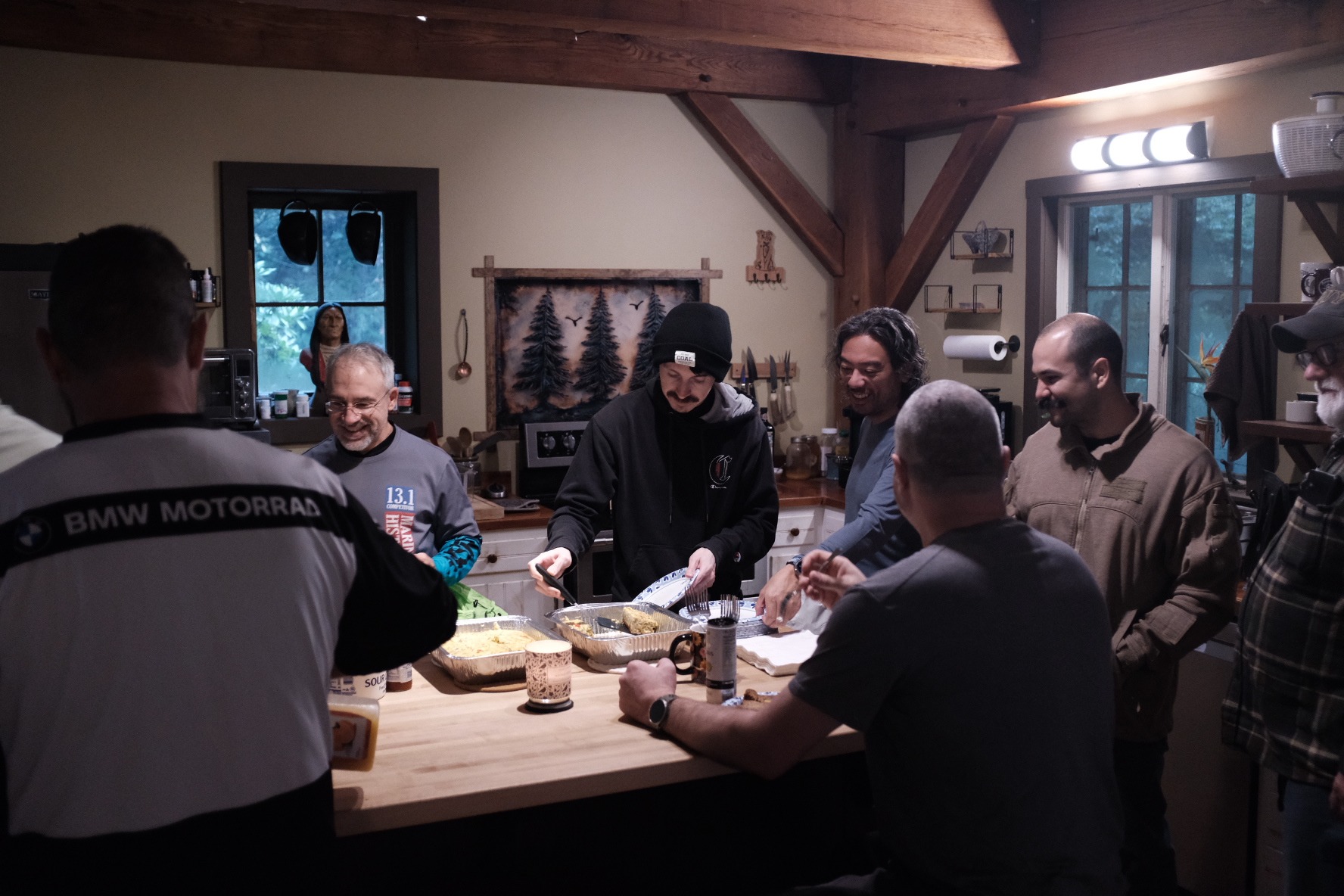 Ride crew sharing a meal in the timber lodge kitchen