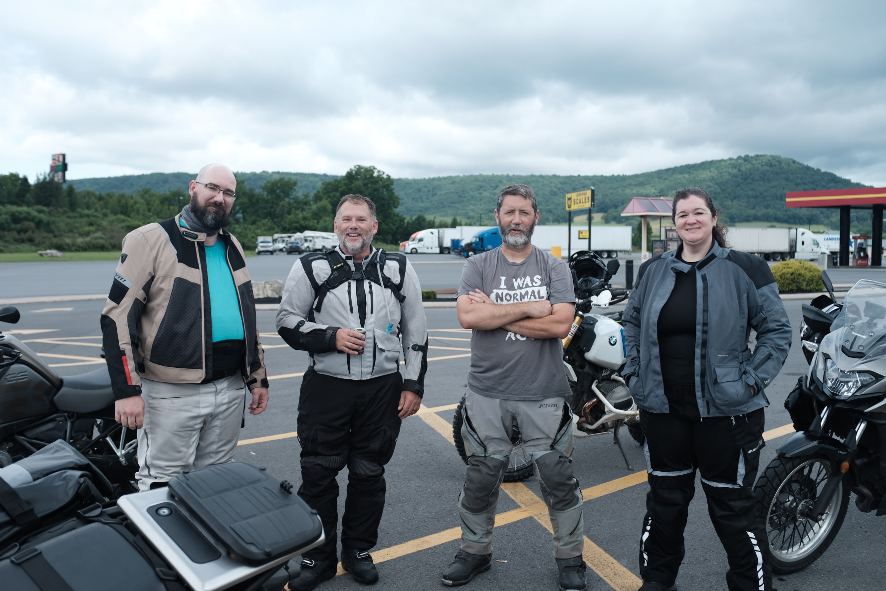 Four riders in gear standing with their adventure bikes before setting off from Milroy, PA