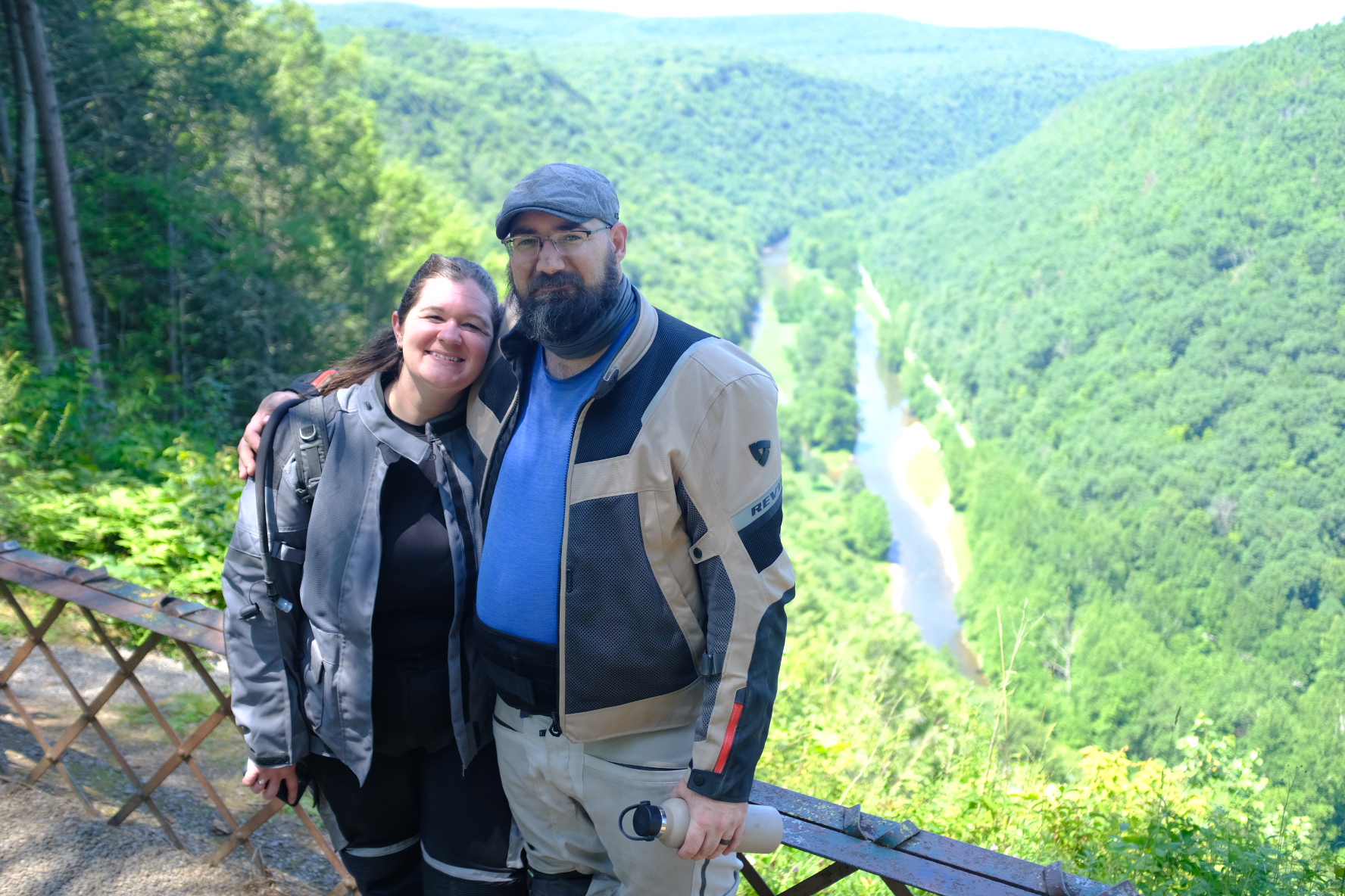 Two riders in gear at a PA Grand Canyon overlook with the river below