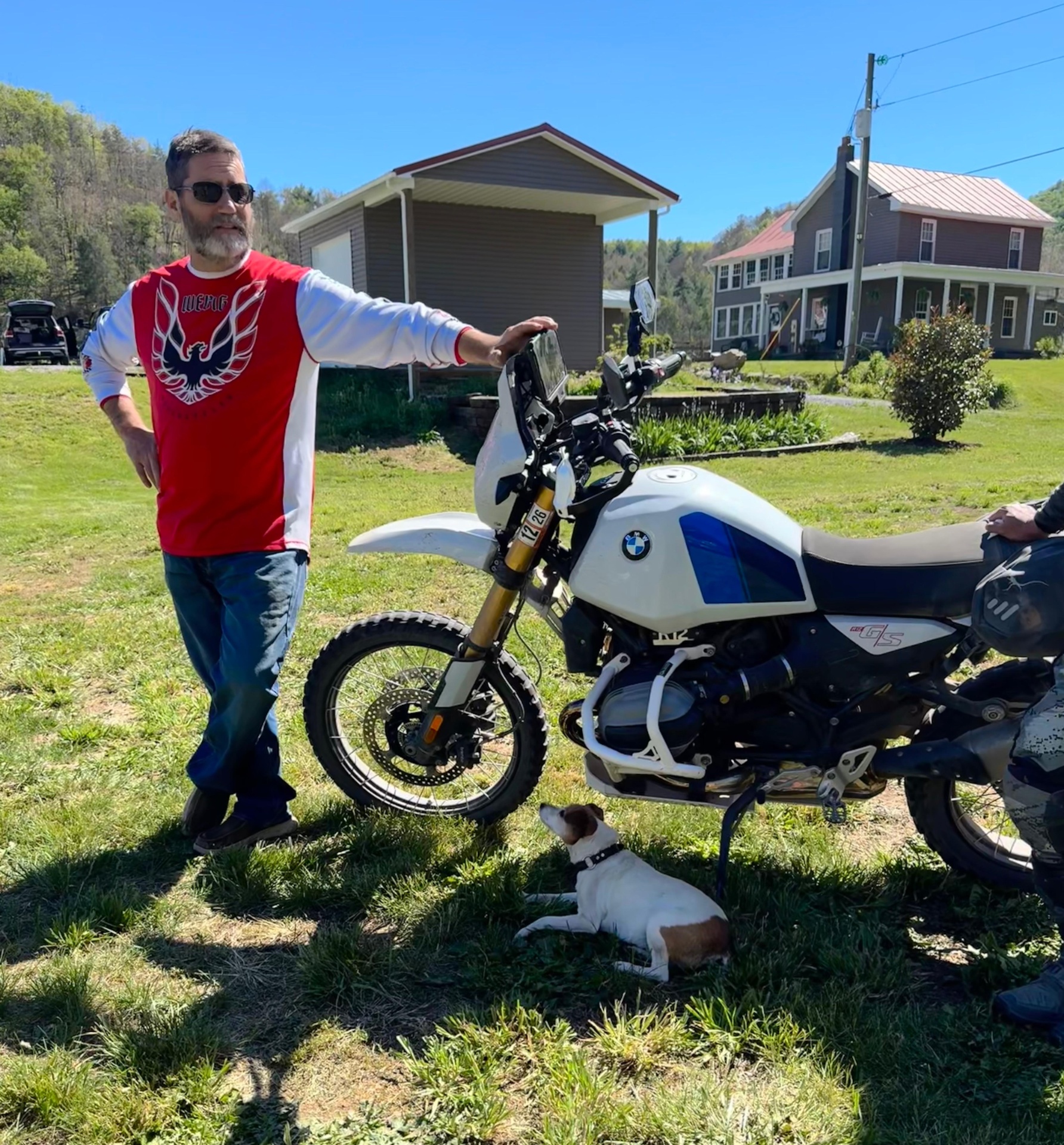 John with his BMW GS adventure bike and a Jack Russell at his feet