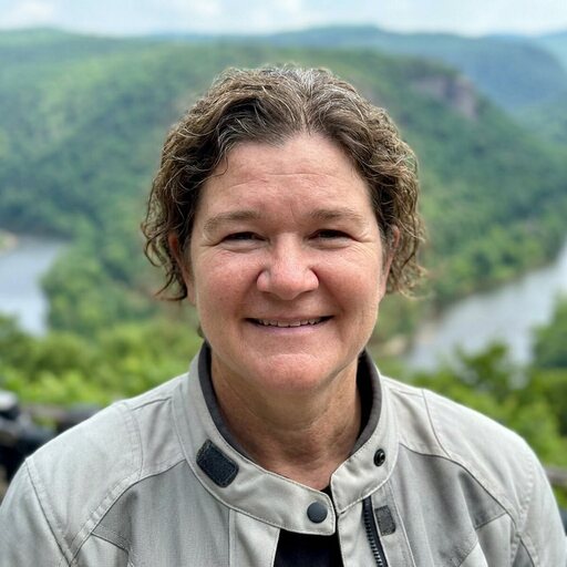 Two adventure riders together at a scenic Appalachian overlook